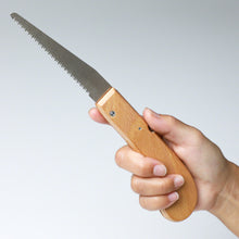 Load image into Gallery viewer, hand holding the folding saw with the blade out