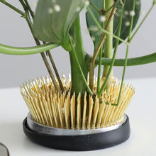 Load image into Gallery viewer, Close up on the radial kenzan with many stems planted on it