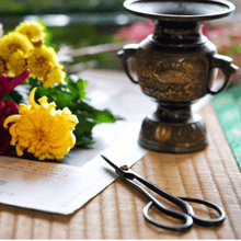 Load image into Gallery viewer, Satsuki in a fashinoable setting with flower and flower vase next to it
